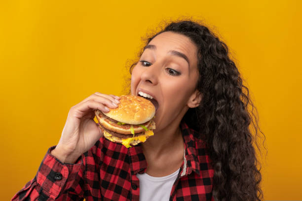 istock Funny Latin Lady Holding Burger Biting Sandwich At Studio 1433036352