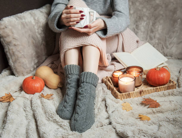 istock Cozy home, woman covered with warm blanket, drinks coffee. 1433037889