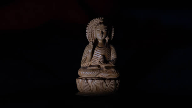 istock WOODEN BUDDHA STATUE IN LUMINANCE LIGHTING. 1433039697