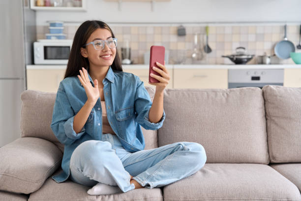 istock Young asian woman making video calling with smartphone at home 1433039811