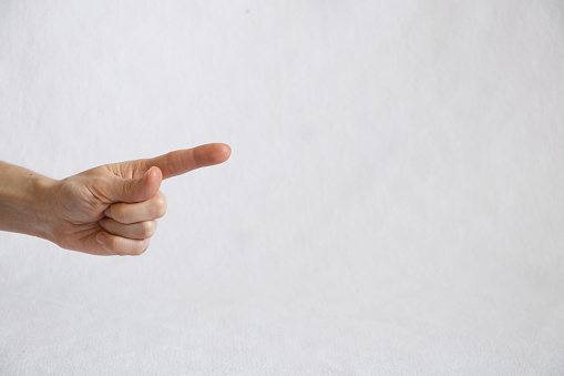 female finger on a white background, finger presses, female hand