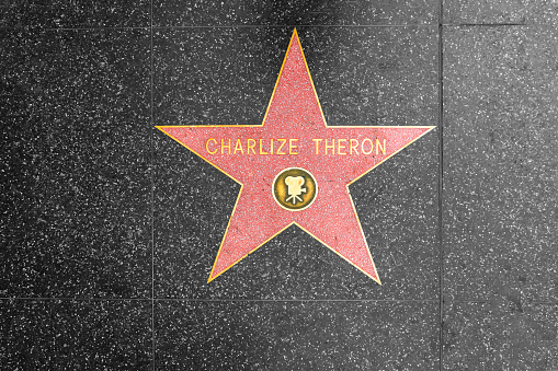 LOS ANGELES, CALIFORNIA, USA - 7 NOV 2019: Walk of fame promenade on Hollywood boulevard in LA. Pedastrians walking near celebrity stars on asphalt. Walkway floor near Dolby and TCL Chinese Theatre.