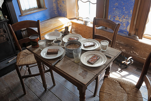 The interior of a Dutch living room from the 1900s, food on the table