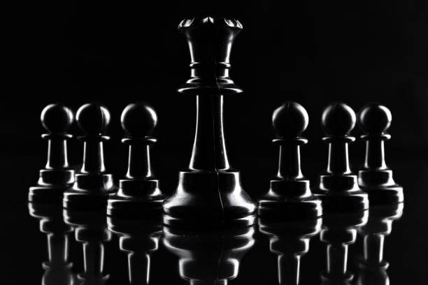 istock Chess figures on dark black background close up 1433047567