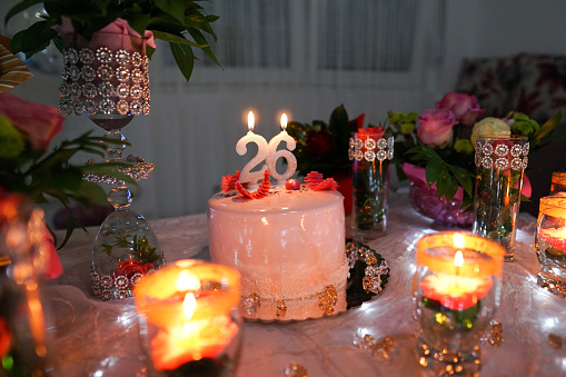 Cakes, sweets and candles on a table, no people birthday decorations