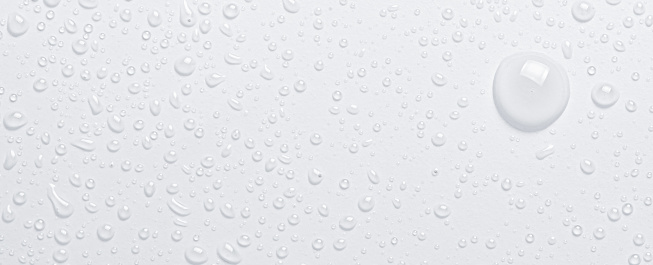 Drops of cosmetic micellar water or tonic. Closeup, macro photography. Copy space