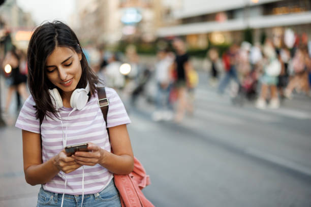 istock Woman using phone in city 1433050954