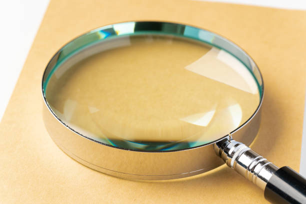 istock Book and magnifying glass on white background 1433051196