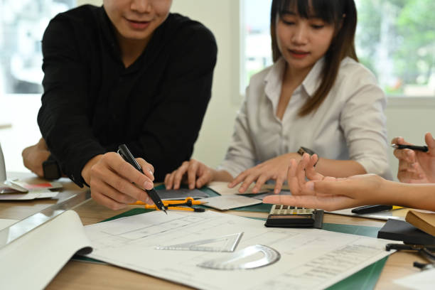 istock Cropped shot of young architects collaborating on new project together in architect studio. 1433055111