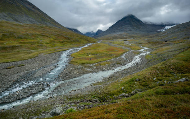 istock Wild river flowing through harsh, remote arctic valley on a cloudy, rainy day of summer. Basstavagge pass in Sarek National Park, Lapland, Sweden. Hiking in remote arctic wilderness of Laponia. 1433055239