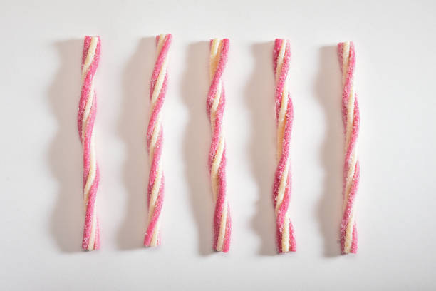 Striped sweet jelly sugar candies in a row on the white background