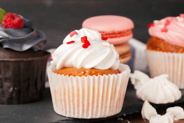 istock Delicious raspberry and caramel cupcakes on dark background 1433057438