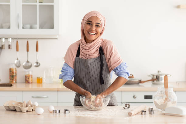 istock Happy Islamic Lady In Hijab Baking In Kitchen, Making Dough For Cookies 1433058657