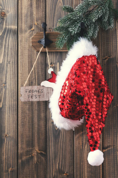 istock Red santa hat hanging on wooden wall. 1433058798