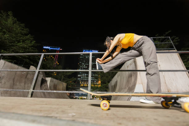 istock Young girl stretching before exercising on extreme skateboard 1433059078