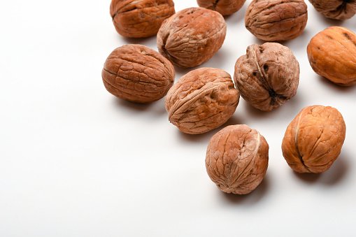 Walnuts on the white background with copy space