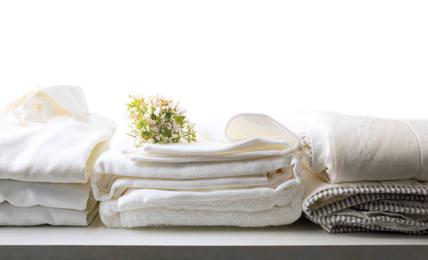 White clean bed and dress clothes on table isolated background