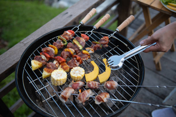 istock Close up of woman's hand preparing barbecue outdoors for dinner 1433061597