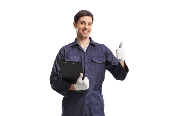 istock Worker in a uniform holding a clipboard and showing thumbs up 1433063709