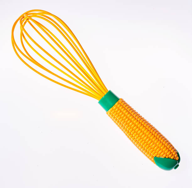 istock A clean new plastic whisk highlighted on a white background. Egg beater handle in the form of corn 1433065879