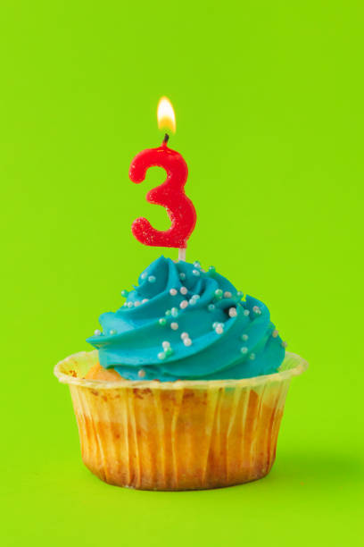 istock Delicious cupcakes with candles on a colored background. Festive background, birthday 1433065981