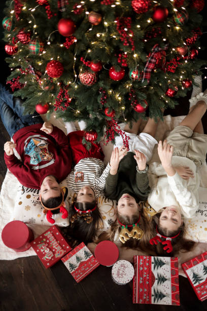 istock Children give gifts under the Christmas tree 1433066243