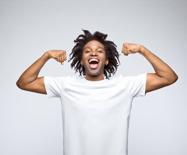 istock Potrait of happy man showing biceps 1433066266