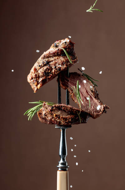 istock Beef steak on a fork sprinkled with rosemary and sea salt. 1433067707