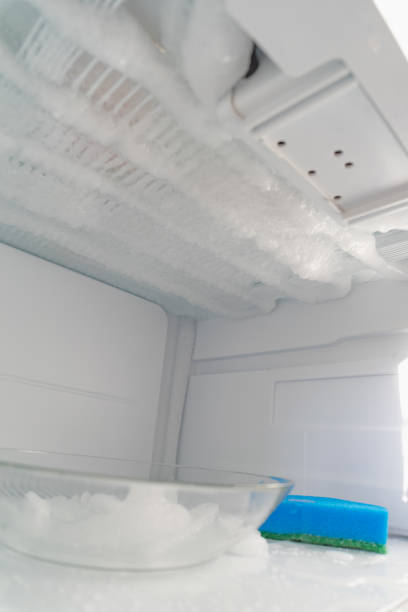 istock Domestic fridge freezer defrost problem concept. Refrigerator covered with ice. Appliance repair concept. Close-up. 1433068563