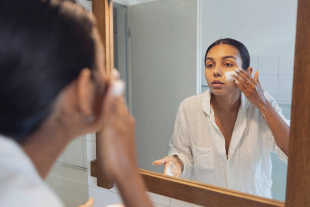 istock woman washing face and looking in mirror at home 1433068930