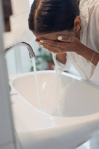 istock woman washing face at home 1433071150