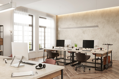 Open plan coworking interior with many desktop computers and large windows in the background. Daylight render.