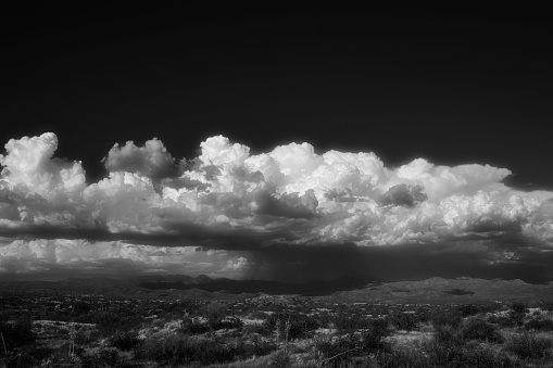 A scenic view of the cloudy sly over the Tonto National Forest, Arizona on a grayscale