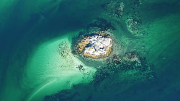 istock Aerial view of the crystal clear turquoise sea water texture with rocks 1433072607
