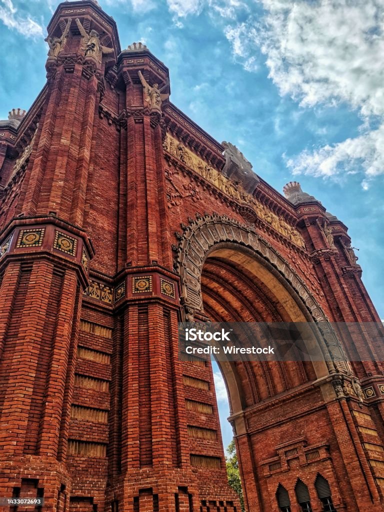 Low angle shot of thr The Arc de Triomf in Barcelona, Spain under blue sky A low angle shot of thr The Arc de Triomf in Barcelona, Spain under blue sky Ancient Stock Photo