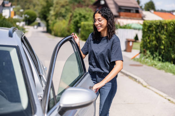 istock Young Hispanic Female Opens Her Silver Car Door, The Window Is Half Open. 1433073011