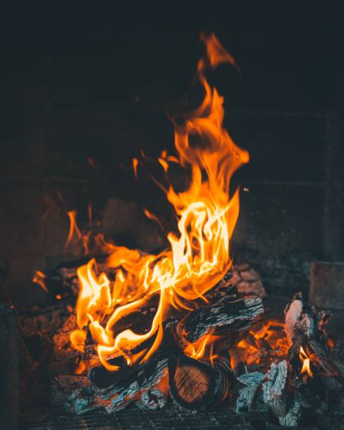 istock Vertical of a burning fire flames captured in a fireplace 1433073263