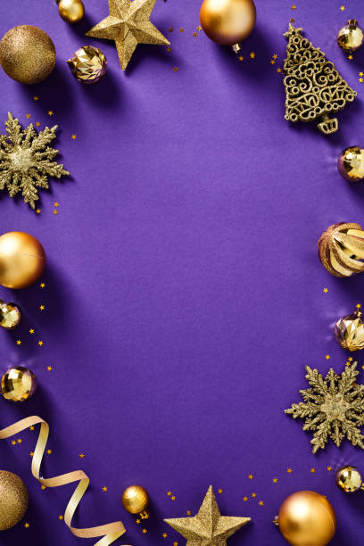 istock Gold Christmas decorations frame on purple background. Flat lay, top view. Xmas vertical banner design, poster template. 1433074000