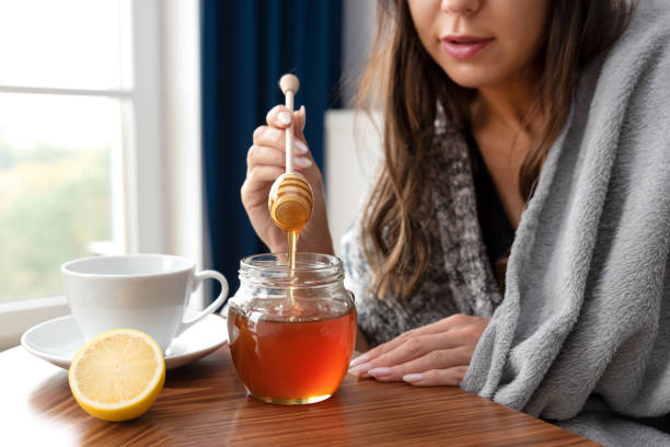 istock Sick woman drinks tea with honey 1433074137