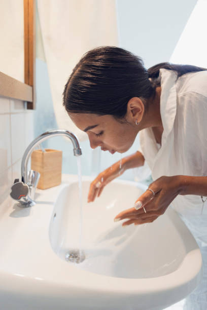 istock woman washing face at home 1433074172