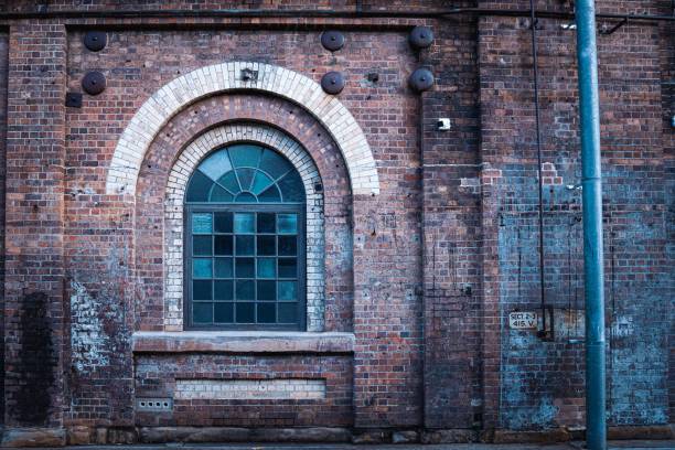 istock Old glass arch window in a brick wall building 1433074549