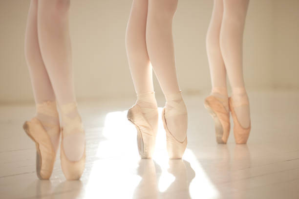 istock Ballet dance woman legs in studio training, exercise and working on performance for competition. Ballerina shoes, teamwork and creative art academy school students learning dancing routine 1433075143