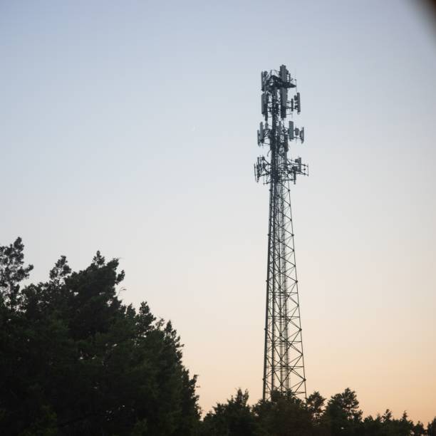 istock Telecommunication tower with trees in the foreground at sunset 1433075551