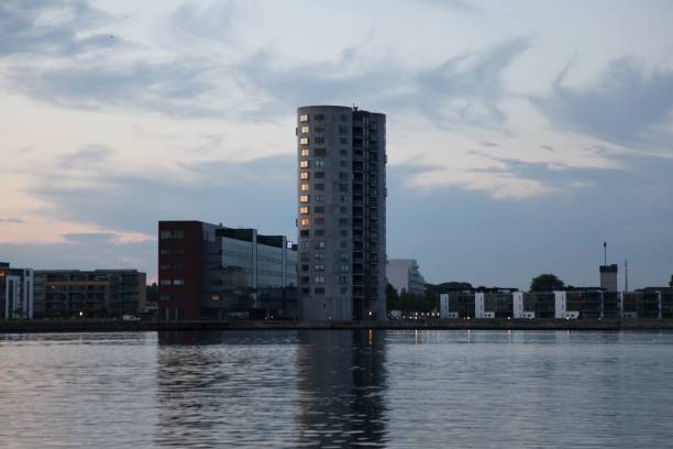istock Tall grain silo with its reflection in the river in Aalborg, Denmark 1433075594