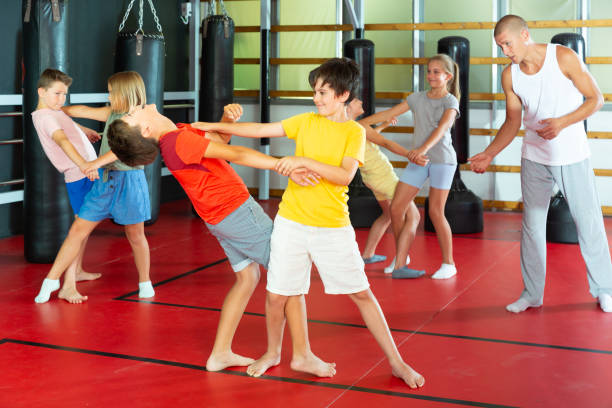 istock Kids in pairs training self-defence moves 1433075647