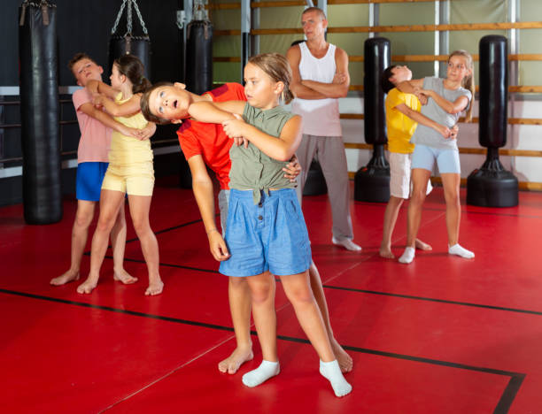 istock Kids in pair exercising self-defense movements 1433075652