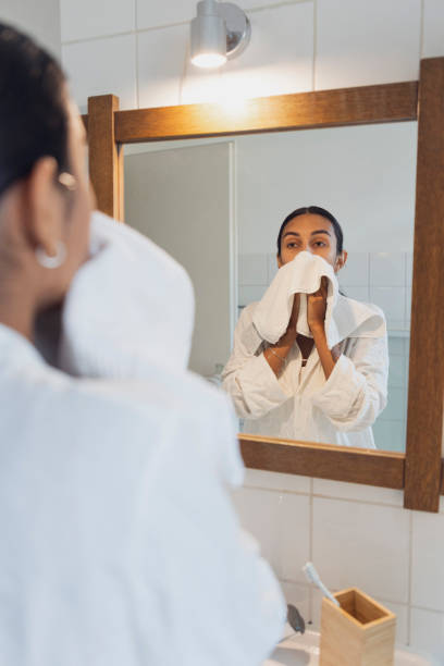 istock Young woman with towel looking in mirror at home 1433076105