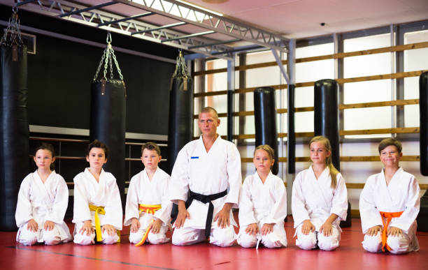 istock Children with their male instructor posing in karate class 1433076266