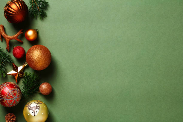 Vintage Christmas baubles and decorations on dark green table. Flat lay, top view, copy space.