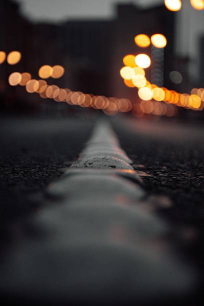 istock Dramatic vertical shot of an asphalt road with light bokeh 1433076605